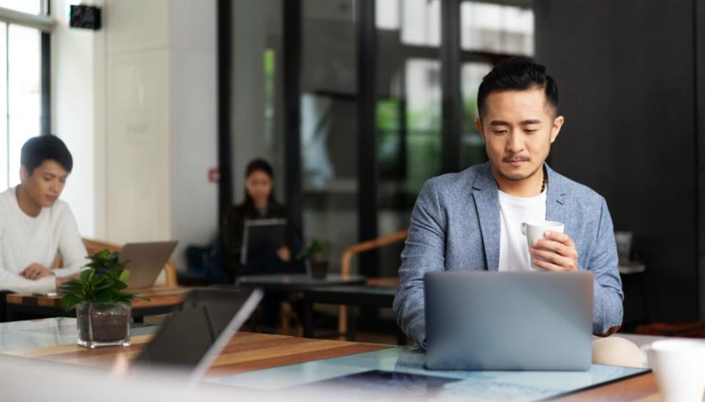 young chinese business people working with laptop