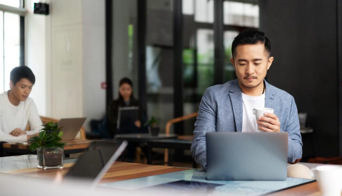 young chinese business people working with laptop